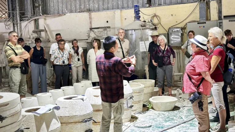 Thuấn accompagne un groupe de voyageurs dans l’atelier de céramique Cương Duyên à Bát Tràng.
